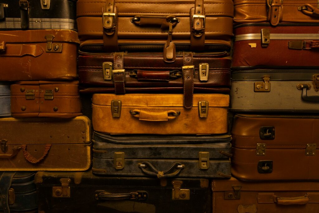 a pile of luggage stacked on top of a suitcase